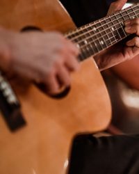 The musician plays and the lead singer sings on stage at the music festival at night.
Concert,mini concert and music festivals.