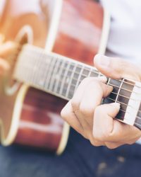 Man playing guitar outdoors